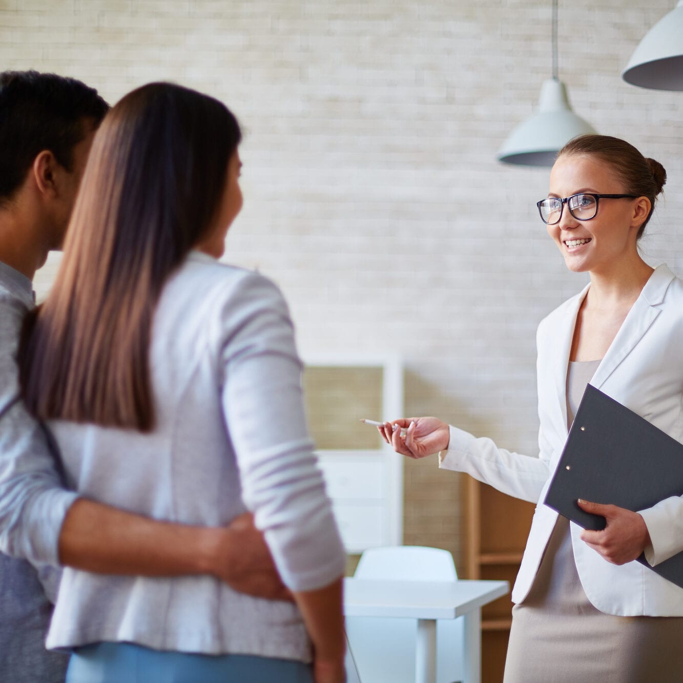 Woman realtor talking to a young family